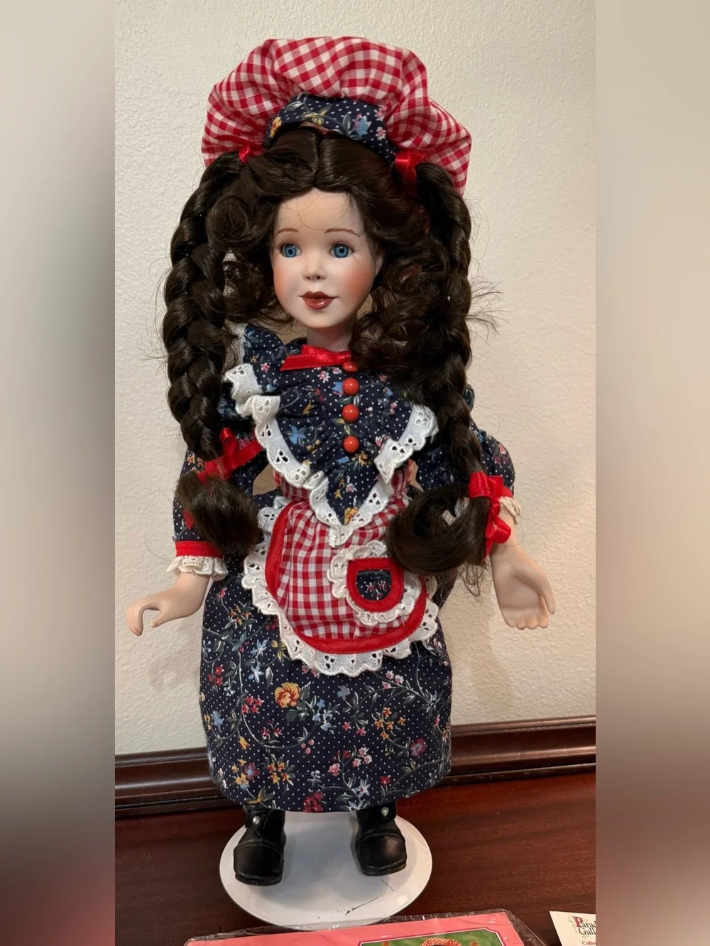 Hannah Porcelain Doll in Navy Floral Dress with Red Gingham Accents